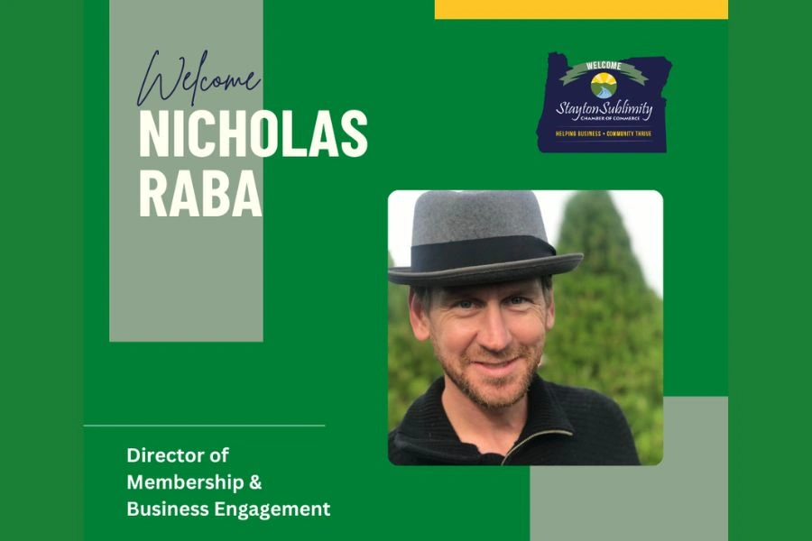 Canva Design welcoing Nicholas Raba as the new Director of Membership & Business Engagement -dark green background - Stayton Sublimity Chamber Logo, grey and yellow accents and picture of Nicholas in grey hat with black band - man in 40's with black shirt and green trees behind